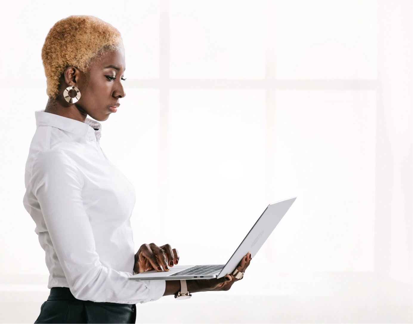 A creative professional from our agency focused on her laptop, crafting the good design that ignites a brand's soul.