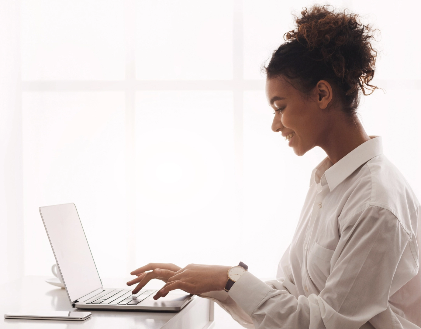 A happy designer from our creative agency smiling as she brings a brand's soul to life through good design.