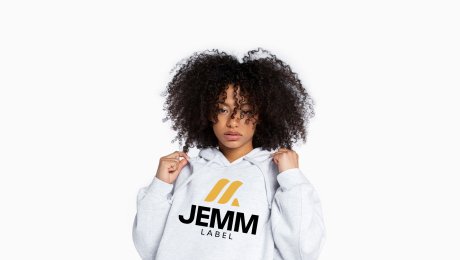 The modern logo and brand identity we created for fashion brand JEMM LABEL, showcased on a grey hoodie.